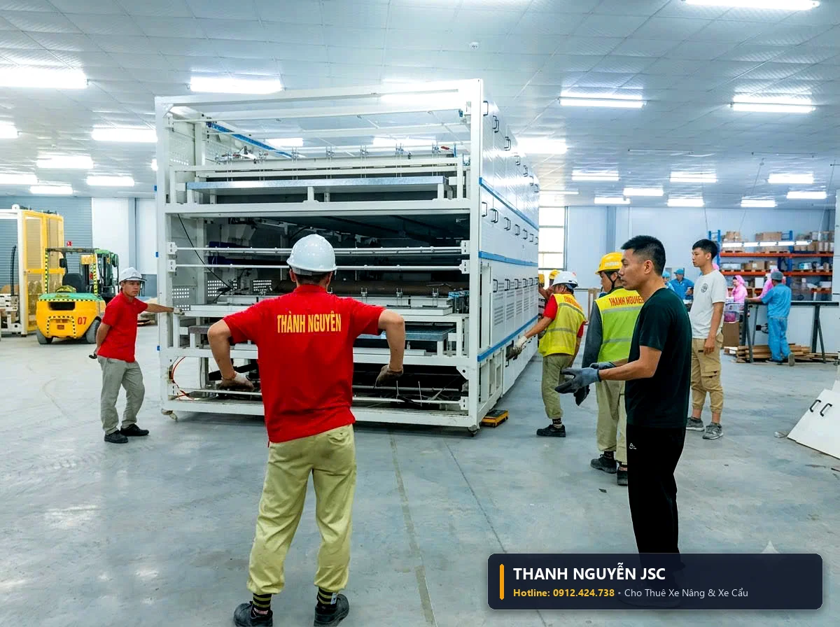 Kỹ sư an toàn THÀNH HUY HOÀNG tại Hải Dương áo đỏ hướng dẫn xe nâng di chuyển cụm khung giàn máy tự động nhiều tầng